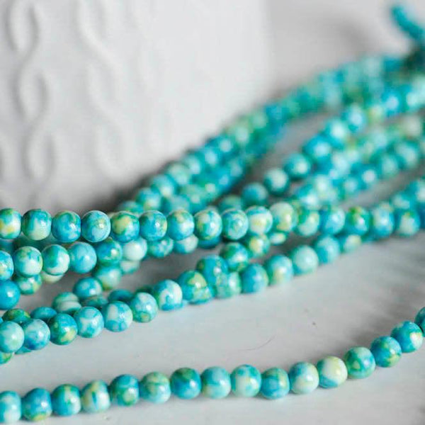 EP Perle jade océan naturel bleue 4mm, x1 fil (G1644)