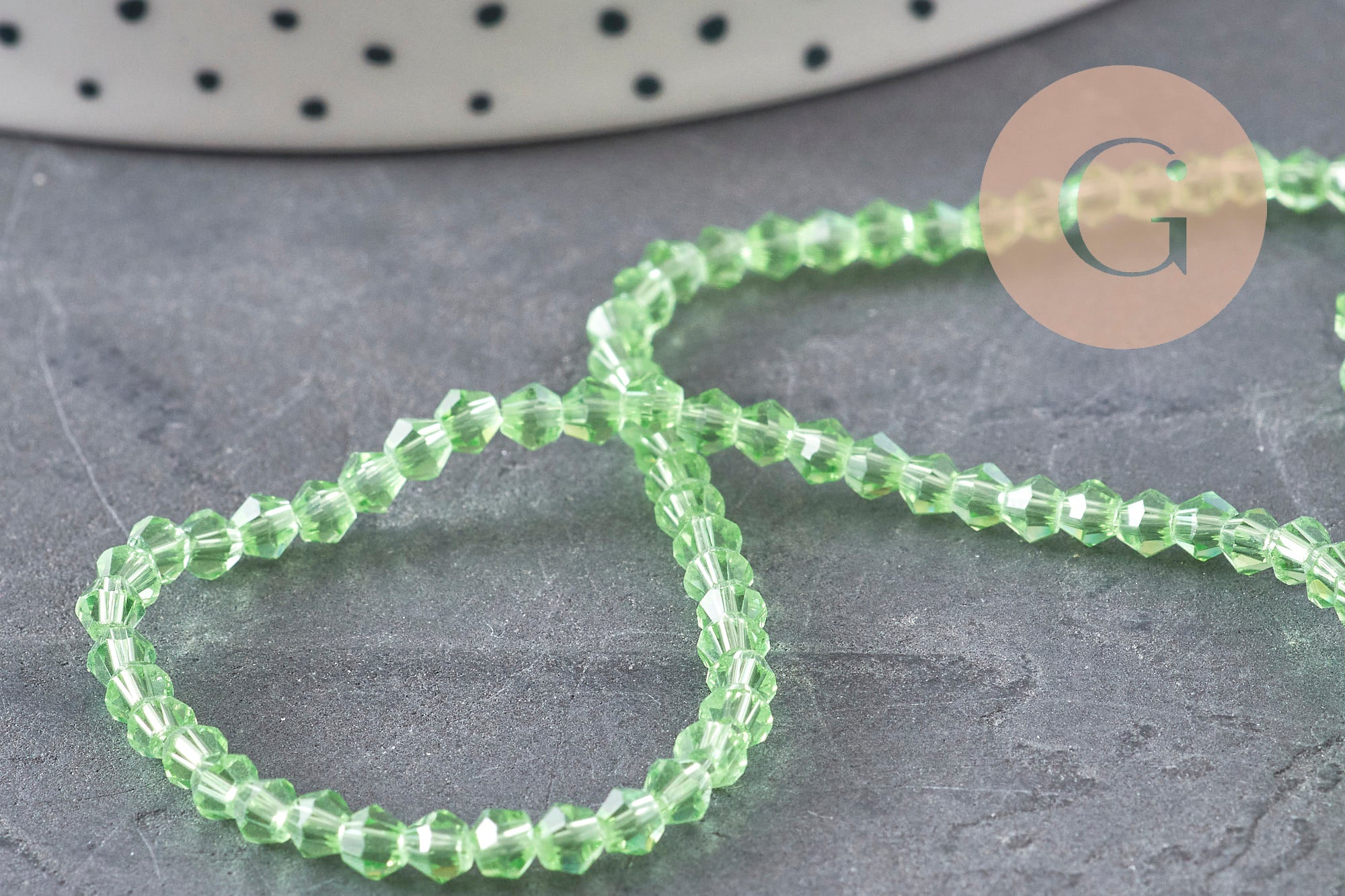Perles cristal toupies à facette vert transparent 3-3.3mm, x1 fil de 38cm (G11111)